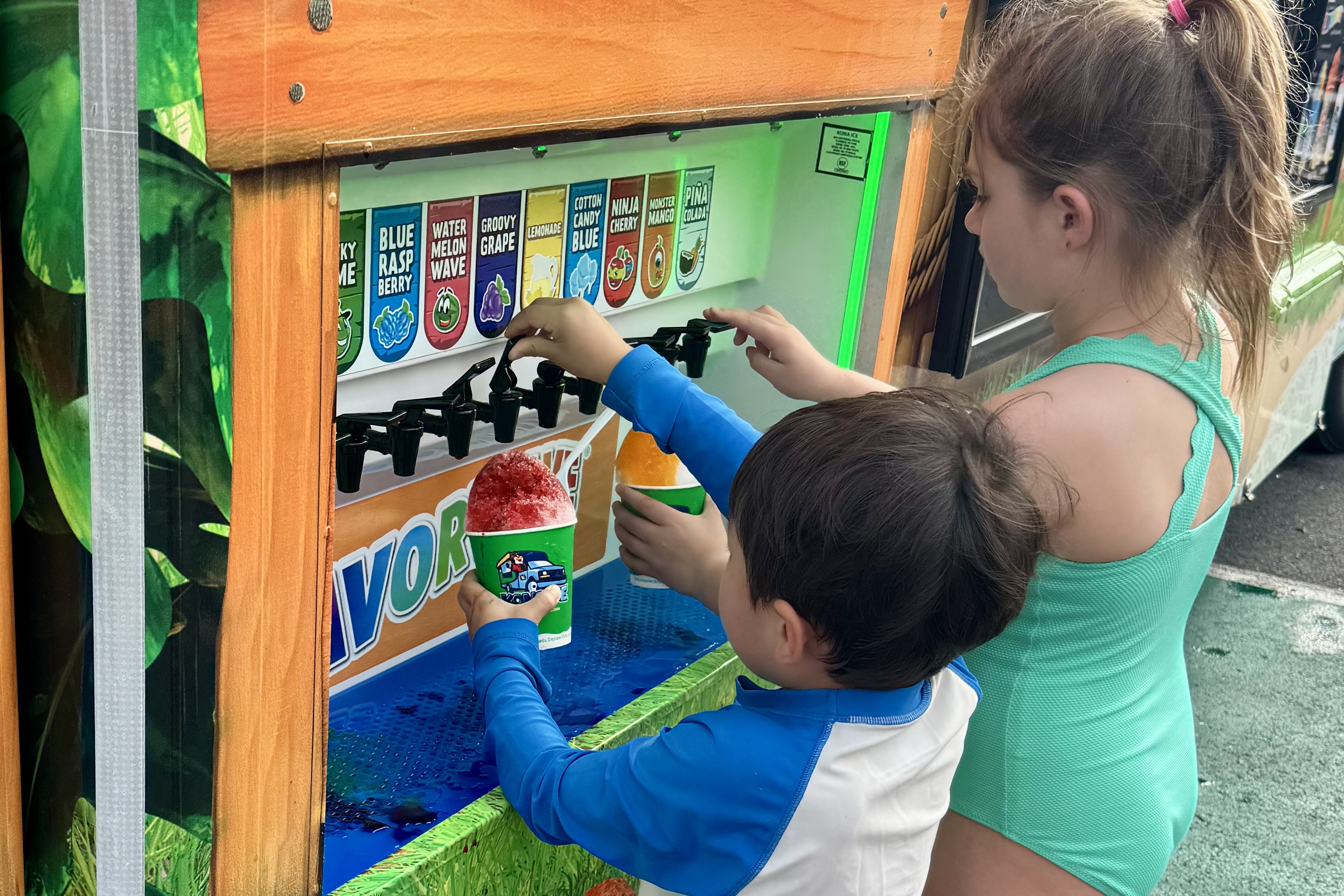 Children at a slushie machine at a school event