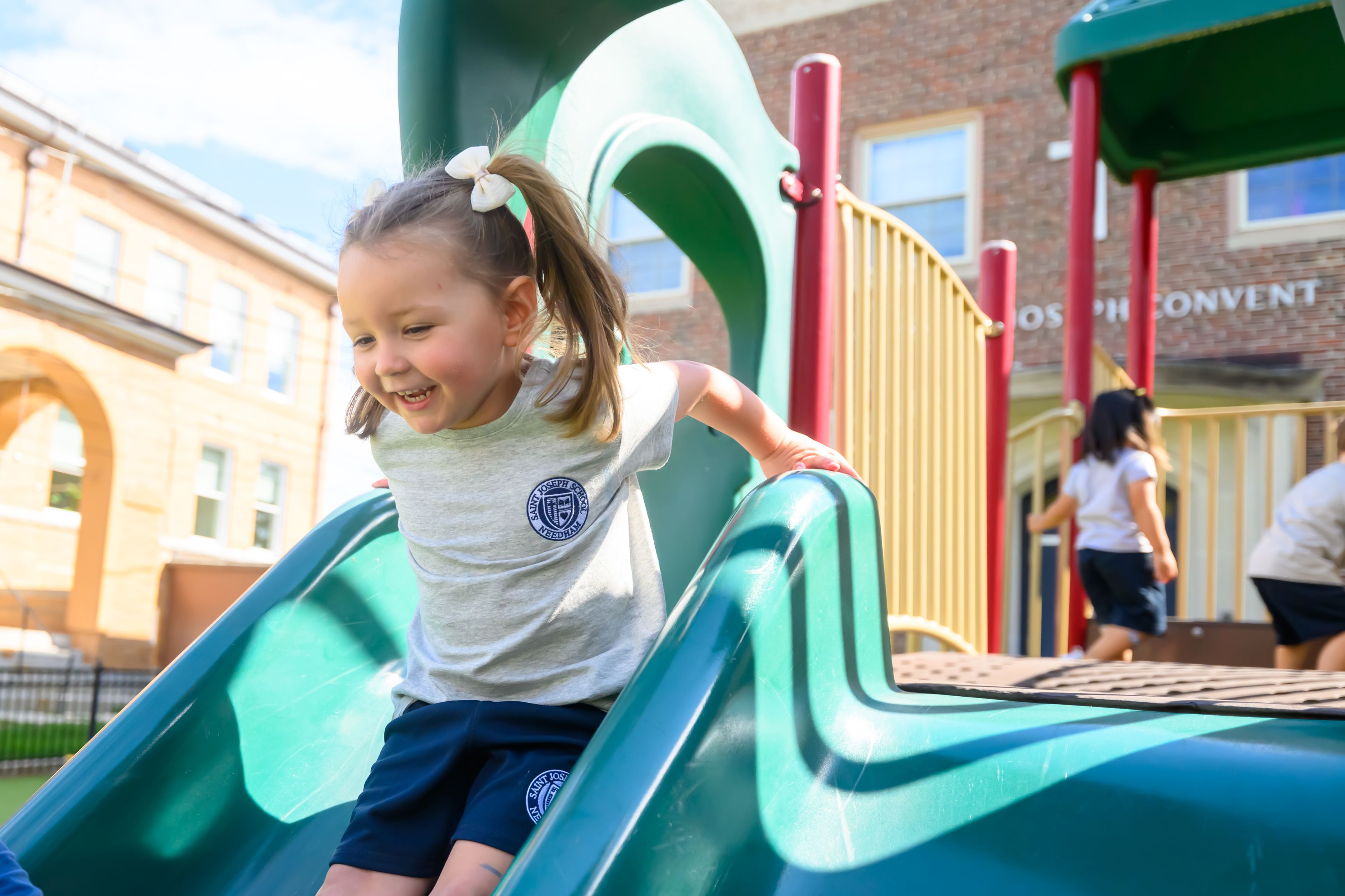 Preschooler on the playground slide