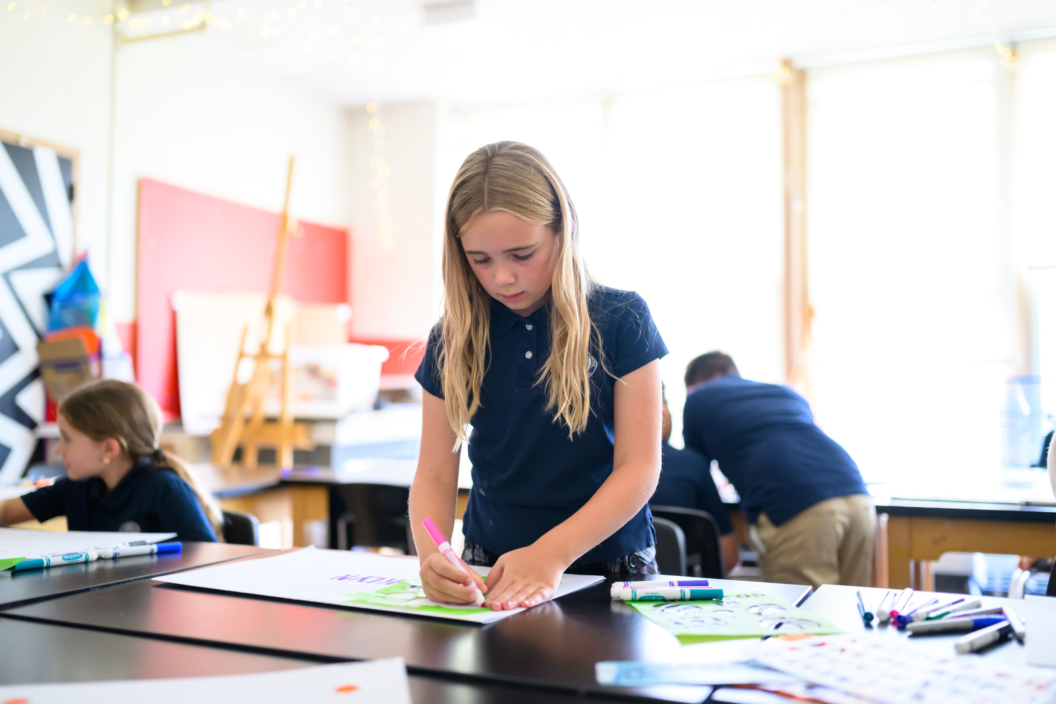A girl tracing with a marker in art class